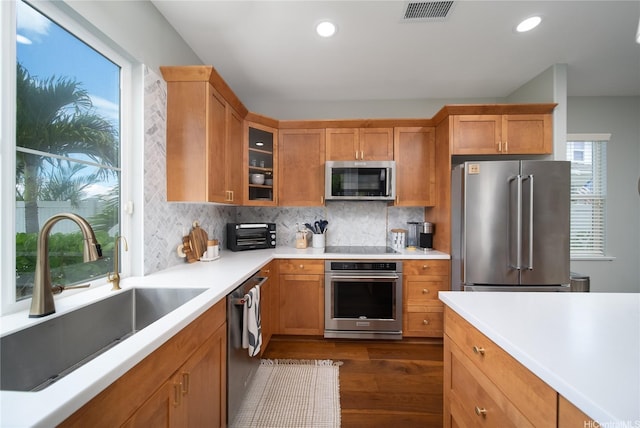 91-1124 Kai Oio St, Ewa Beach, HI 96706 - kitchen with appliances with stainless steel finishes, a sink, glass insert cabinets, decorative backsplash, and recessed lighting