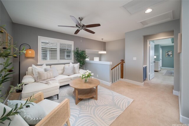 91-1124 Kai Oio St, Ewa Beach, HI 96706 - living area with attic access, light carpet, baseboards, and a ceiling fan