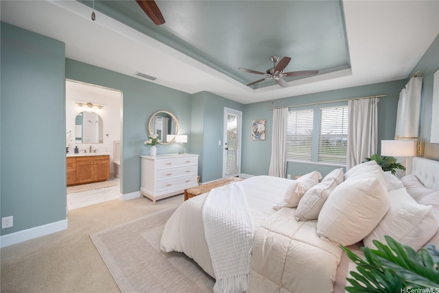 91-1124 Kai Oio St, Ewa Beach, HI 96706 - bedroom with a raised ceiling, light carpet, ensuite bathroom, a sink, and baseboards