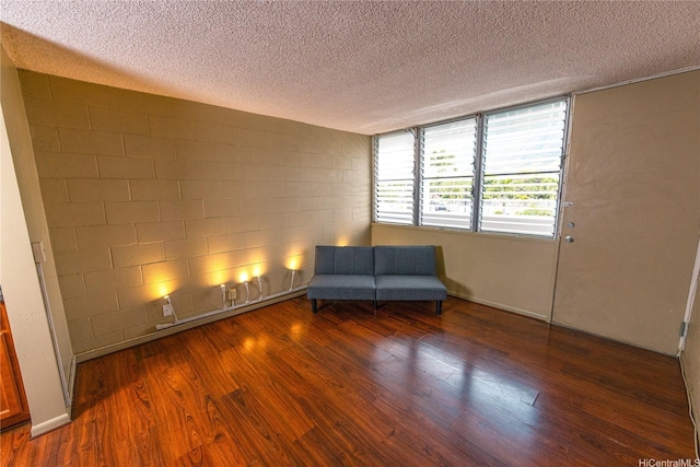 84-965 Farrington Hwy Unit B216, Waianae, HI 96792 - sitting room with a textured ceiling, wood finished floors, and concrete block wall