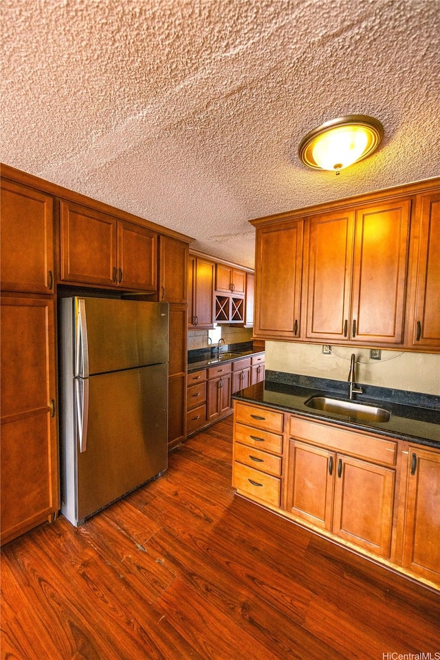 84-965 Farrington Hwy Unit B216, Waianae, HI 96792 - kitchen featuring freestanding refrigerator, a sink, dark wood finished floors, dark countertops, and a textured ceiling