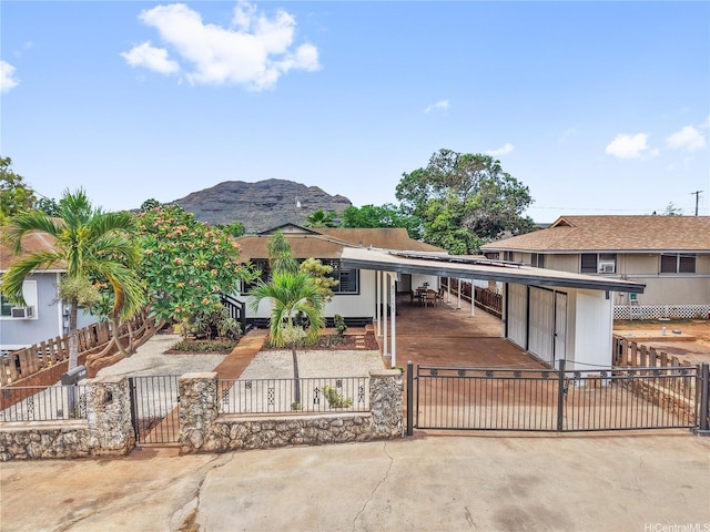 87-153 Kimo St, Waianae, HI 96792 - view of front facade with a gate, a fenced front yard, a mountain view, and a carport