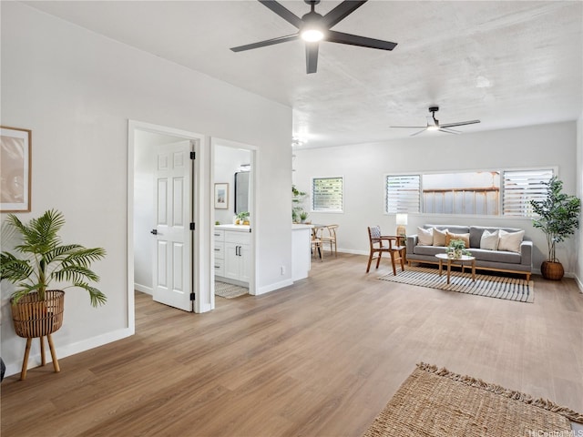 87-153 Kimo St, Waianae, HI 96792 - living area with a ceiling fan, light wood finished floors, and plenty of natural light