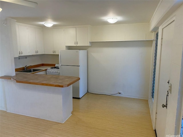 1617 Miller St Unit 3, Honolulu, HI 96813 - kitchen with white appliances, light wood-type flooring, a peninsula, tile countertops, and white cabinetry