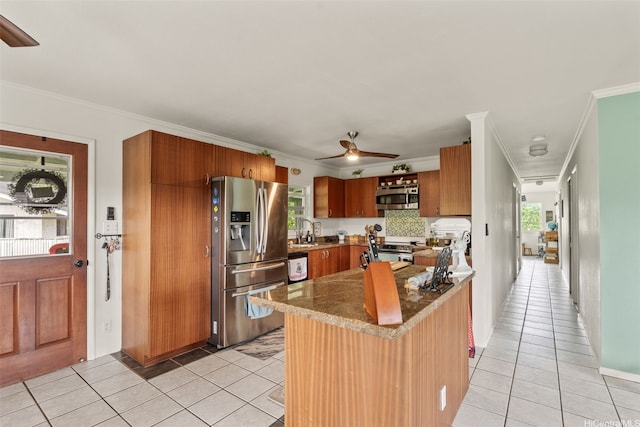 51-17 Kaaawa Pl, Kaaawa, HI 96730 - kitchen featuring appliances with stainless steel finishes, a ceiling fan, light tile patterned flooring, crown molding, and brown cabinetry