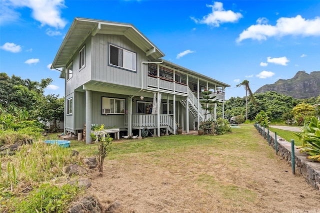 51-17 Kaaawa Pl, Kaaawa, HI 96730 - rear view of property featuring a lawn, a mountain view, stairway, and a porch