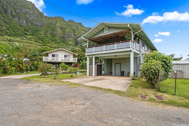51-17 Kaaawa Pl, Kaaawa, HI 96730 - view of front of house featuring dirt driveway, a carport, and a balcony