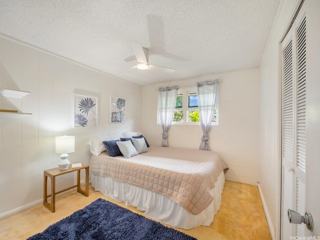 1257 Maleko St, Kailua, HI 96734 - bedroom with light carpet, a textured ceiling, a closet, baseboards, and a ceiling fan