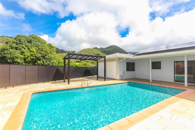 view of swimming pool featuring a pergola, a patio area, and a fenced backyard