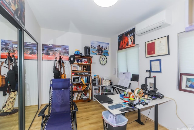 office featuring an AC wall unit and wood finished floors