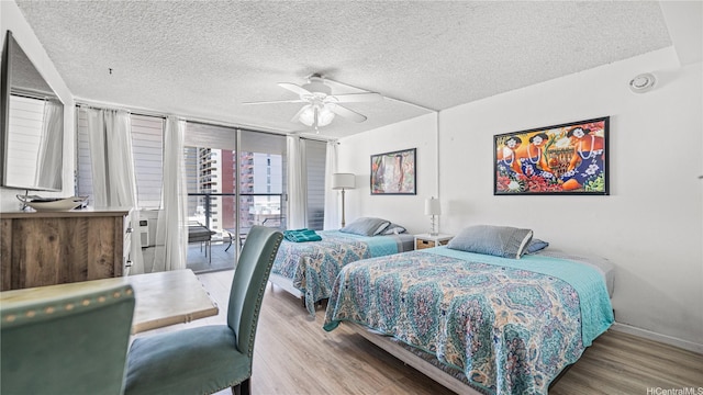 445 Seaside St Unit 1205, Honolulu, HI 96815 - bedroom featuring wood finished floors, a textured ceiling, access to exterior, a ceiling fan, and baseboards
