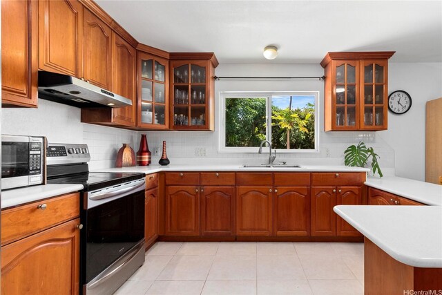 99-060 Nalopaka Pl, Aiea, HI 96701 - kitchen featuring under cabinet range hood, stainless steel appliances, tasteful backsplash, light countertops, and brown cabinets
