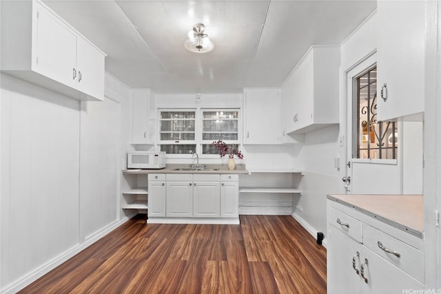 99-060 Nalopaka Pl, Aiea, HI 96701 - kitchen featuring white microwave, dark wood-type flooring, white cabinetry, and light countertops
