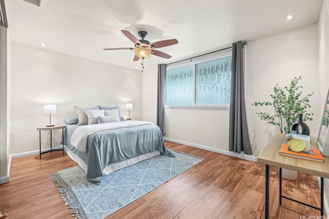 500 Lunalilo Home Rd Unit 22C, Honolulu, HI 96825 - bedroom with baseboards, wood finished floors, and ceiling fan