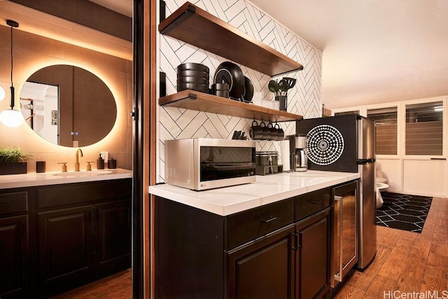 84-965 Farrington Hwy Unit A502, Waianae, HI 96792 - kitchen featuring a sink, open shelves, decorative backsplash, and wood finished floors