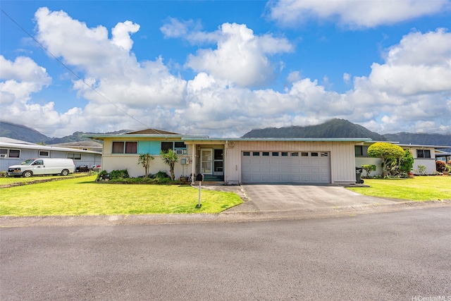 45-155 Pahikoli Pl, Kaneohe, HI 96744 - ranch-style house featuring a garage, concrete driveway, a front yard, and a mountain view