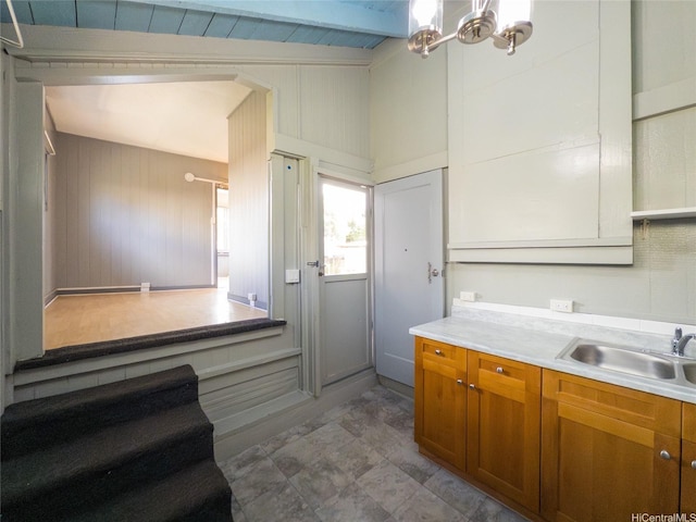 3140 Paliuli St, Honolulu, HI 96816 - kitchen featuring brown cabinetry, a sink, light countertops, a chandelier, and beamed ceiling