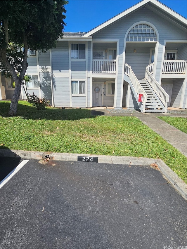 94-209 Paioa Pl Unit L 205, Waipahu, HI 96797 - view of building exterior with uncovered parking and stairway