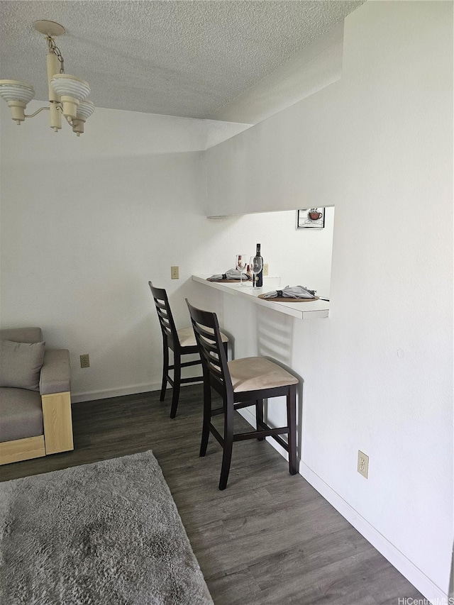 94-209 Paioa Pl Unit L 205, Waipahu, HI 96797 - office featuring wood finished floors, a textured ceiling, a chandelier, baseboards, and a dry bar