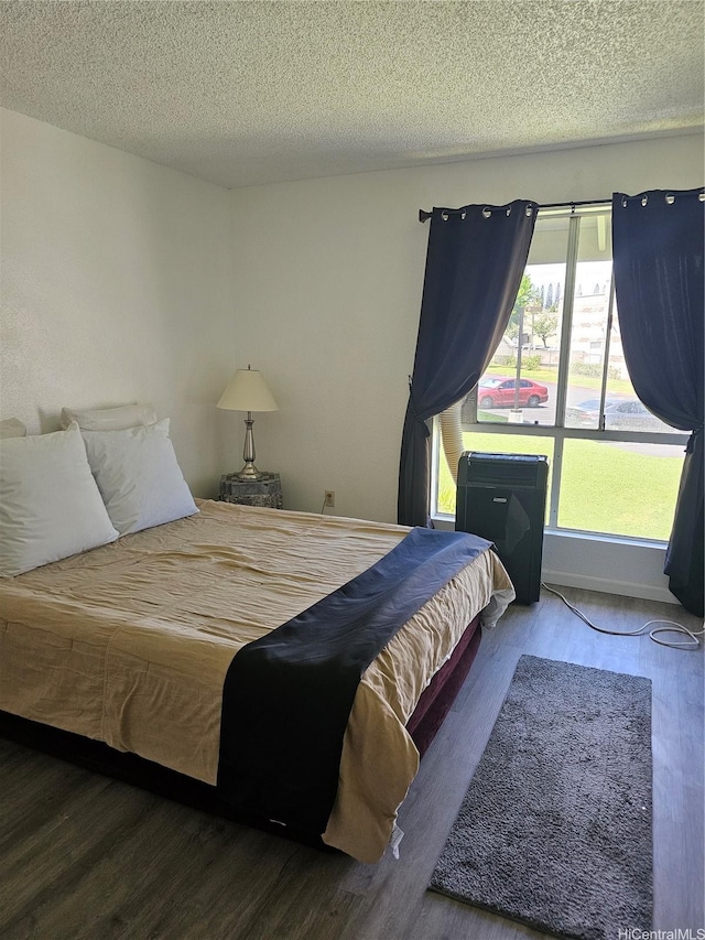 94-209 Paioa Pl Unit L 205, Waipahu, HI 96797 - bedroom with wood finished floors and a textured ceiling