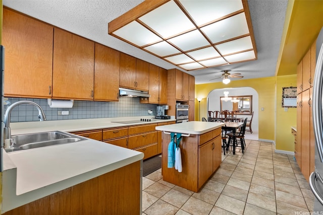 98-042 Puaalii Way, Aiea, HI 96701 - kitchen with a sink, oven, under cabinet range hood, arched walkways, and black electric cooktop