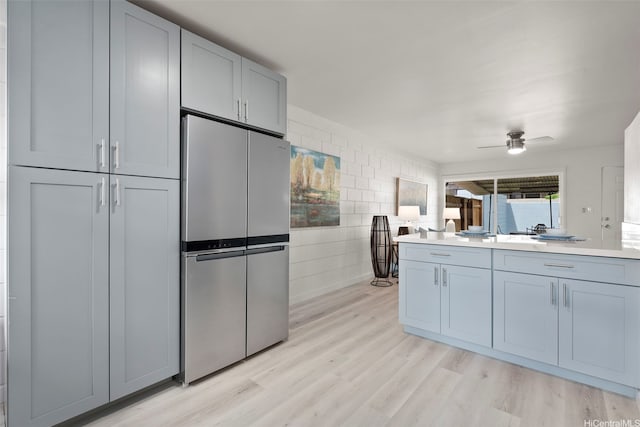 1210 Hooli Cir, Pearl City, HI 96782 - kitchen featuring freestanding refrigerator, light wood-style floors, ceiling fan, light countertops, and tile walls