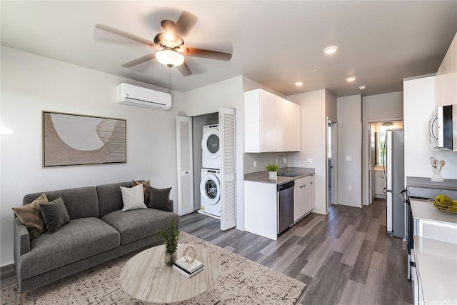 91-3617 Kamolehonua St Unit 613, Ewa Beach, HI 96706 - living area featuring stacked washer and clothes dryer, a wall mounted AC, recessed lighting, a ceiling fan, and dark wood-type flooring