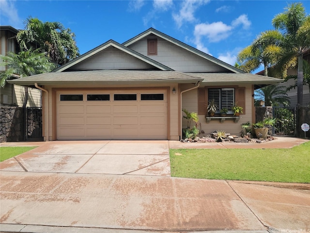 91-1565 Wahane St, Kapolei, HI 96707 - view of front of house with roof with shingles, concrete driveway, and an attached garage
