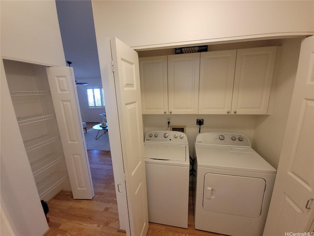 91-1565 Wahane St, Kapolei, HI 96707 - washroom with cabinet space, washer and dryer, and light wood-style flooring