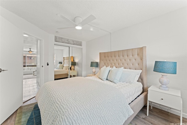 92-1132 Panana St Unit 130, Kapolei, HI 96707 - bedroom with wood finished floors, a closet, ceiling fan, and a textured ceiling