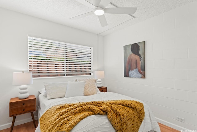 92-1132 Panana St Unit 130, Kapolei, HI 96707 - bedroom featuring wood finished floors, a textured ceiling, baseboards, and a ceiling fan