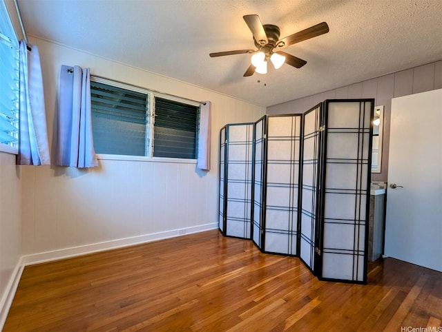 82-6148 Hoomaka Pl, Captain Cook, HI 96704 - unfurnished room with wood finished floors, ceiling fan, baseboards, vaulted ceiling, and a textured ceiling