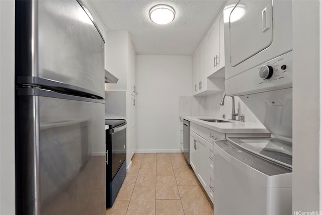 98-1042 Moanalua Rd Unit 2-303, Aiea, HI 96701 - washroom with stacked washer and clothes dryer, a textured ceiling, and light tile patterned floors