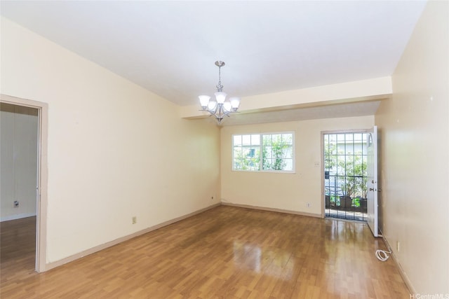 94-1190 Kahuanui St, Waipahu, HI 96797 - empty room featuring a chandelier, light wood-type flooring, and baseboards