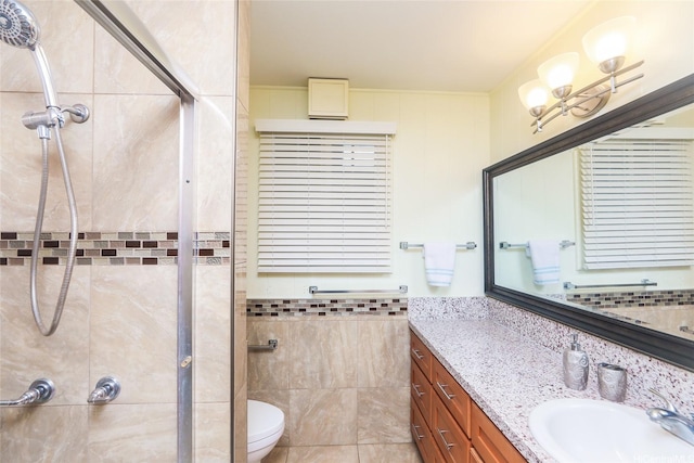 94-1190 Kahuanui St, Waipahu, HI 96797 - full bathroom featuring tile walls, a tile shower, vanity, toilet, and wainscoting