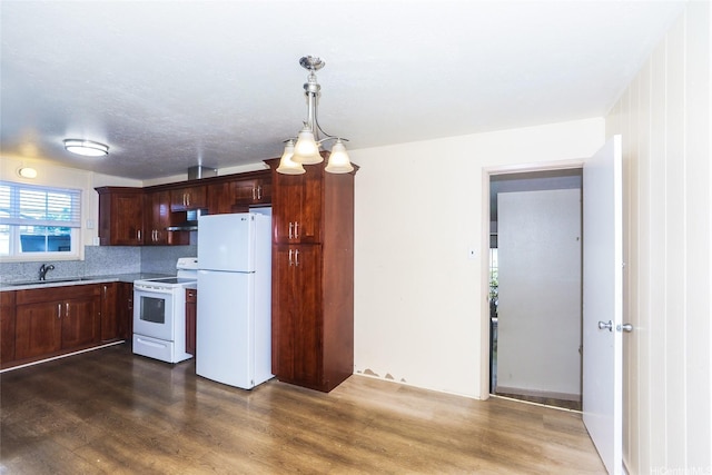 94-1190 Kahuanui St, Waipahu, HI 96797 - kitchen with white appliances, under cabinet range hood, a sink, dark wood-style floors, and light countertops