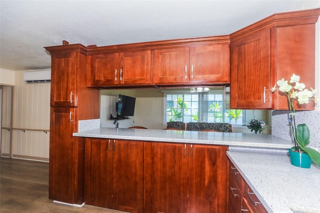 94-1190 Kahuanui St, Waipahu, HI 96797 - kitchen with a wall mounted AC, dark wood-style floors, light stone counters, and a peninsula