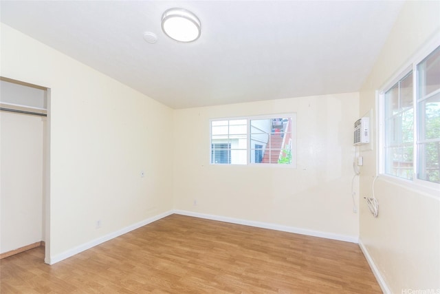 94-1190 Kahuanui St, Waipahu, HI 96797 - unfurnished bedroom featuring multiple windows, light wood-style floors, and baseboards