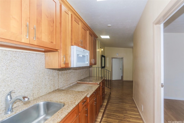 94-1190 Kahuanui St, Waipahu, HI 96797 - kitchen with white microwave, a sink, dark wood-style floors, and backsplash