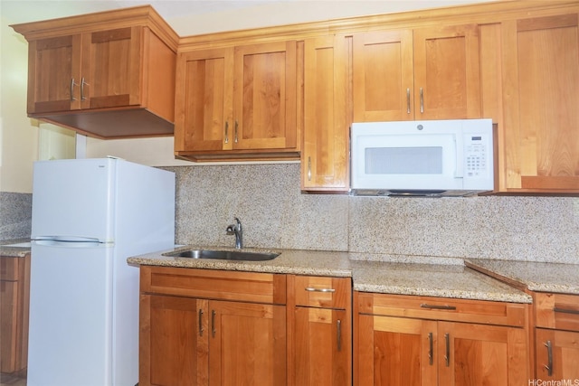 94-1190 Kahuanui St, Waipahu, HI 96797 - kitchen with white appliances, a sink, backsplash, and light stone counters