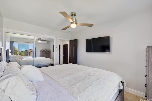 92-1041 Makakilo Dr Unit 82, Kapolei, HI 96707 - bedroom with baseboards, light wood-style flooring, a wall unit AC, and a ceiling fan