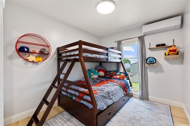 92-1041 Makakilo Dr Unit 82, Kapolei, HI 96707 - bedroom with a wall mounted AC, baseboards, and wood finished floors