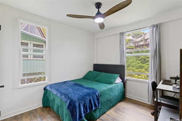 45-173 Kokokahi Pl, Kaneohe, HI 96744 - bedroom with wood finished floors, a decorative wall, a ceiling fan, and crown molding