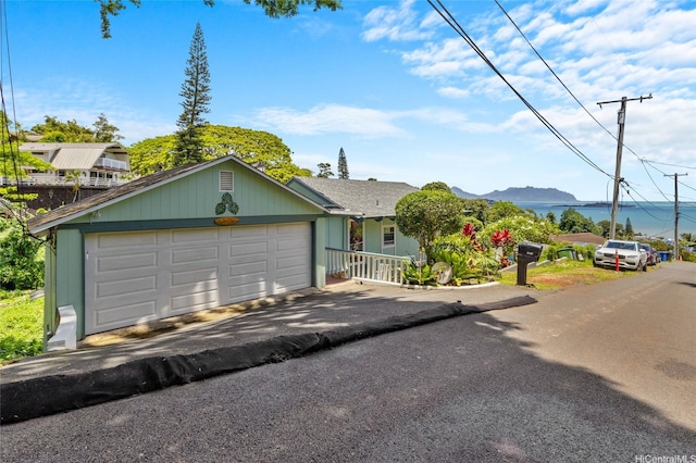 45-173 Kokokahi Pl, Kaneohe, HI 96744 - view of front of property featuring a garage, asphalt driveway, and a mountain view