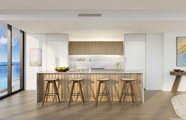 928 Ala Moana Blvd Unit 2711, Honolulu, HI 96814 - kitchen featuring modern cabinets, white cabinets, wood finished floors, backsplash, and floor to ceiling windows