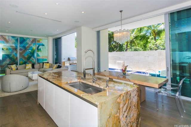 1118 Ala Moana Blvd Unit 2, Honolulu, HI 96814 - kitchen with a sink, dark wood finished floors, light stone countertops, plenty of natural light, and recessed lighting