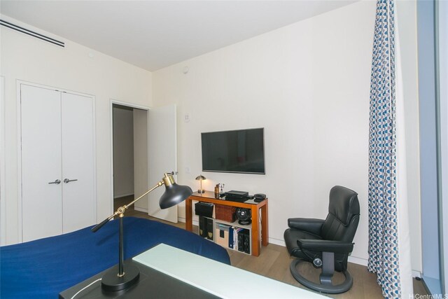 1118 Ala Moana Blvd Unit 2, Honolulu, HI 96814 - bedroom with wood finished floors, a closet, an office area, and baseboards