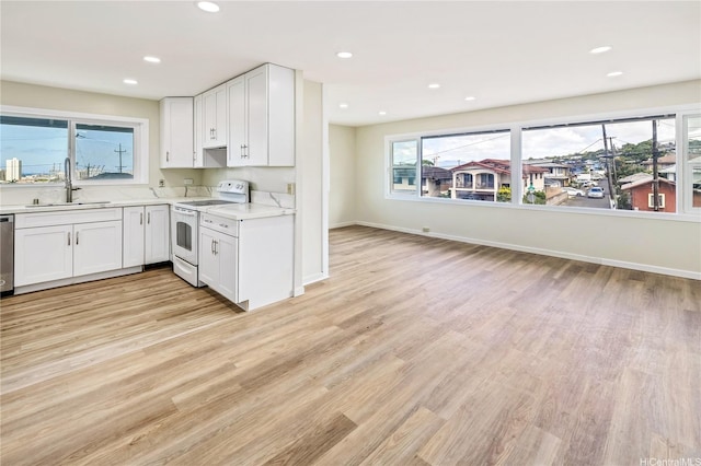 2017 Liliha St, Honolulu, HI 96817 - kitchen with white electric range oven, a sink, light wood finished floors, light countertops, and white cabinetry