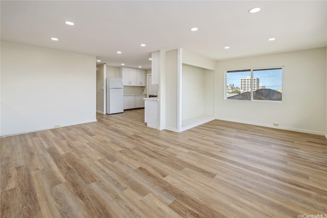 2017 Liliha St, Honolulu, HI 96817 - unfurnished living room featuring light wood-style flooring, recessed lighting, and baseboards