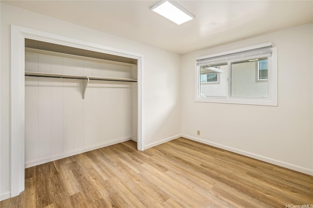 2017 Liliha St, Honolulu, HI 96817 - unfurnished bedroom with a closet, light wood-style flooring, and baseboards